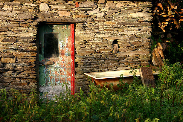 Stone cottage with bathtub stock photo