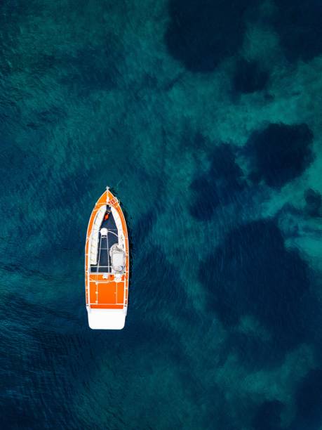istock Red boat in deep blue water. Aerial view 914429152
