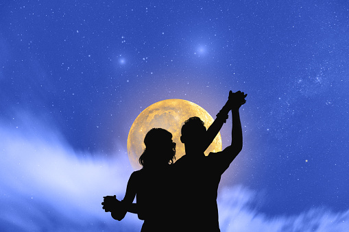 Young couple dancing under the moonlight and stars. My astronomy work.
