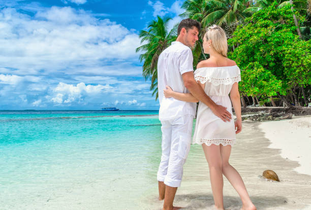 istock two lovers, hugging each other strolling along the Maldivian island 914435466