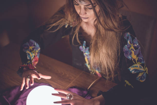 istock Girl with crystal magic ball 914436198