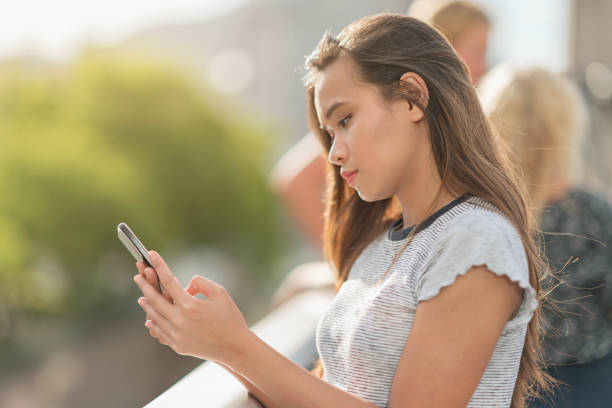 istock Young asian woman checking messages on her smart phone 914442892