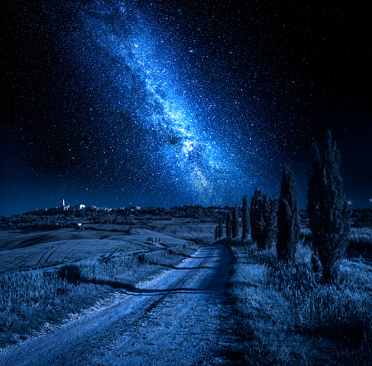 Country road leading to Pienza with stars at night