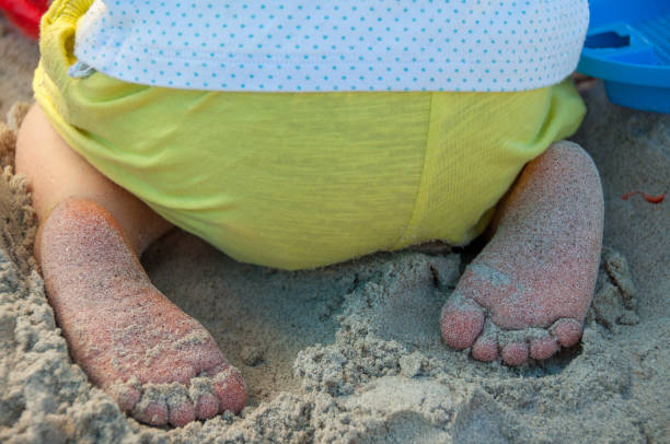istock Baby  playing in the sand, on a beach 914444046