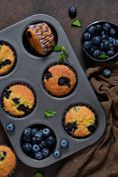 istock Homemade vanilla muffins with blueberries on a dark concrete background.Rustic! 914444240