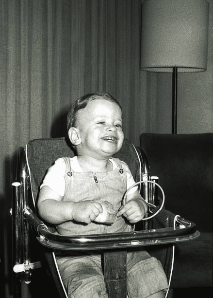 istock Vintage black and white baby boy laughing 914447088