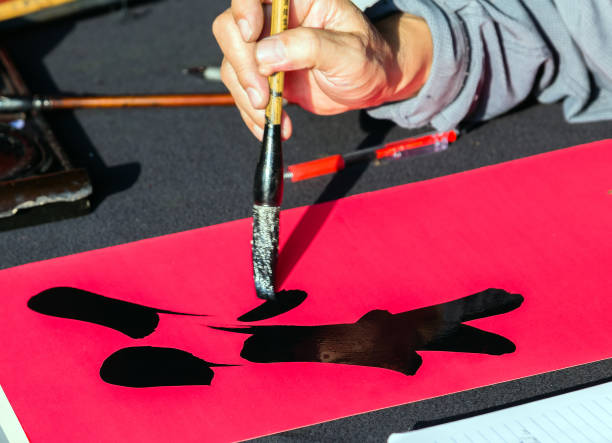 istock Calligrapher hands writing chinese hieroglyph, prosperous in Chinese word 914449784