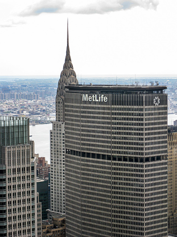 The cityscape of Manhattan midtown, Metlife and Chrysler Building, the Hudson river and Brooklyn\n