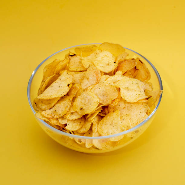 istock A plate of chips on a yellow background closeup 914450208