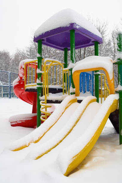 istock Slide in the playground under a thick layer of snow. 914451494