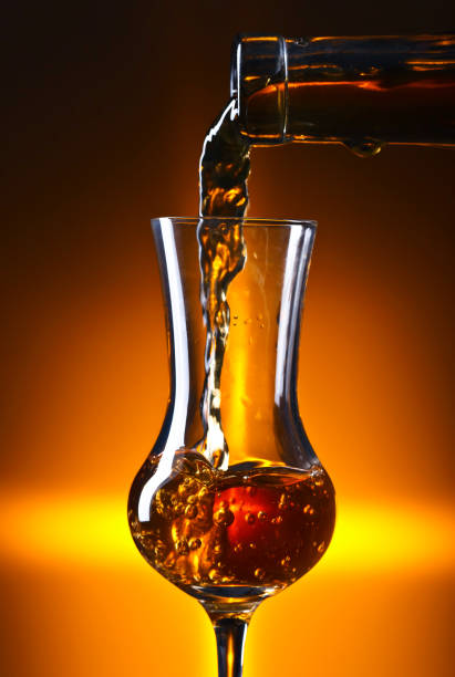 istock Pouring alcohol drink into a wineglass . 914451860