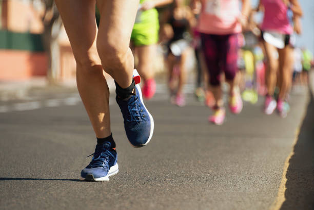 istock Marathon runners running on city road 914458804