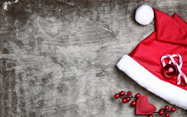 istock red santa hat on grey textured wooden background 914459360