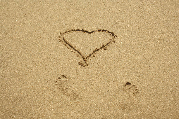 istock Heart and footprints in the sand 91445999