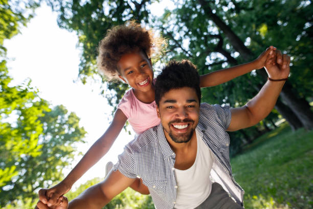istock Smiling father giving his daughter piggyback ride 914462474