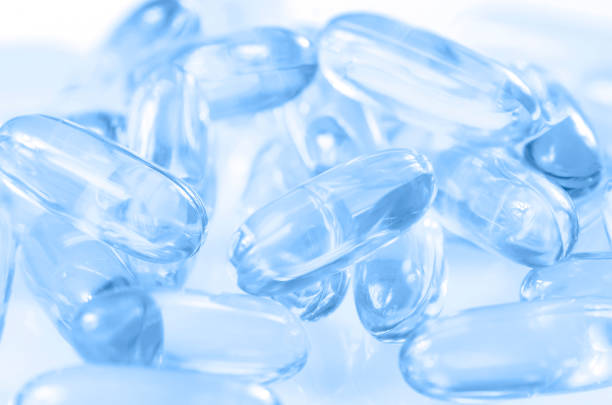 soft gelatin capsule use in pharmaceutical manufacturing. - fish oil vegetable capsule healthy eating imagens e fotografias de stock