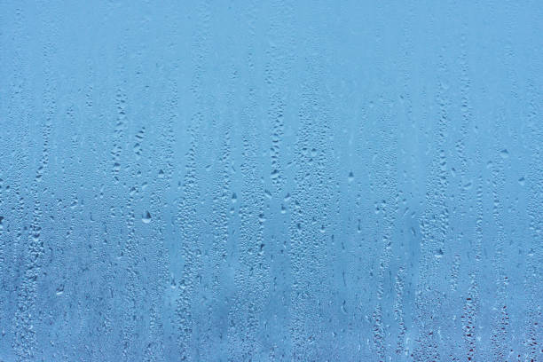 istock Natural blue water drop background on glass 914466788