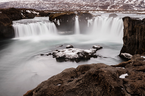 water flowing from frozen godaoss waterfalls, Iceland