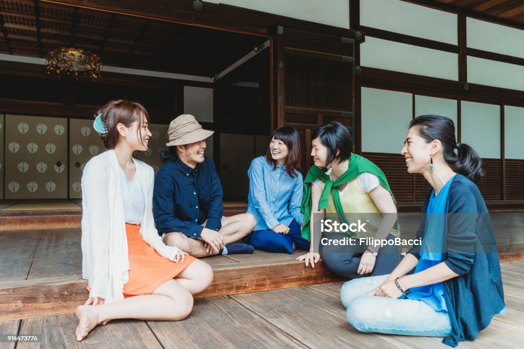 Group Of Japanese Friends Talking Together Stock Photo Download Image