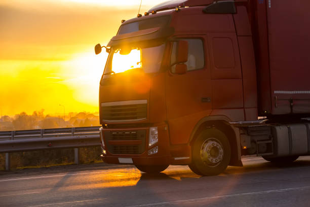 istock truck goes on highway on sunset 914474770