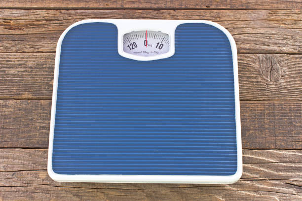 istock Weight bathroom scale on wooden floor 914478572
