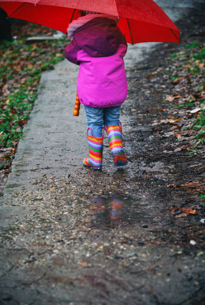 istock Small girl with the large umbrella 914481530