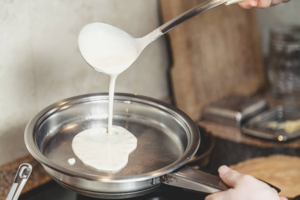 istock liquid dough is poured onto frying pan 914482122