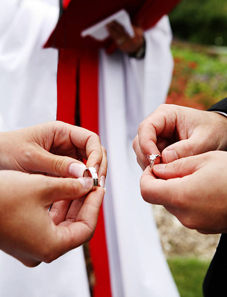 istock Bride and groom exchanging wedding rings 91448242