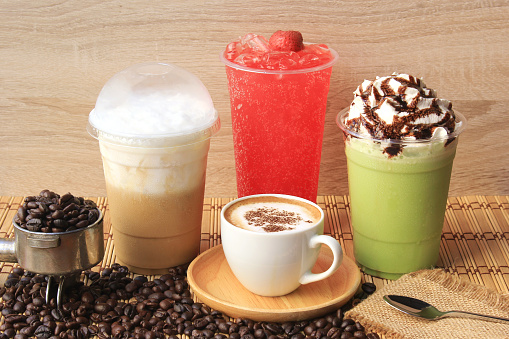 Hot coffee cup with coffee beans on the wooden table, Cold coffee, Iced matcha green tea and fruit soda for summer drink