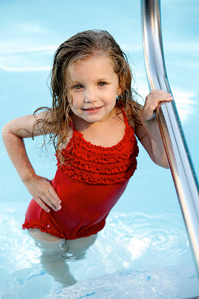 Little girl in pool stock photo