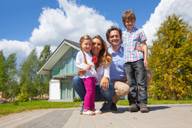 istock Happy family and their house 914484920