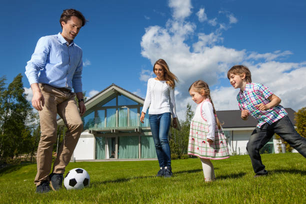 istock Family playing soccer outside 914484980