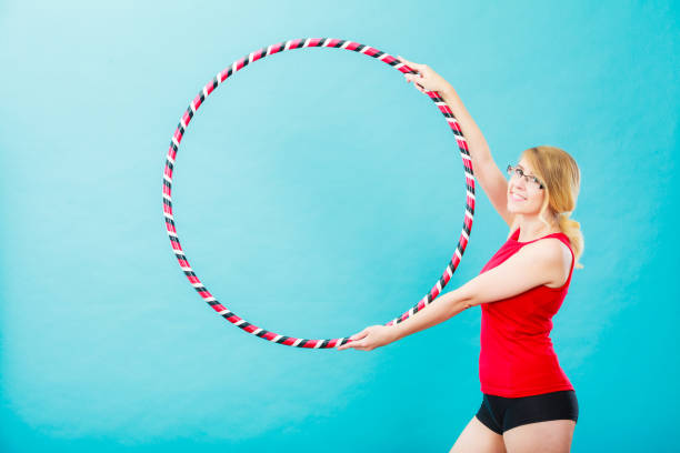 istock Fit woman with hula hoop doing exercise 914485112