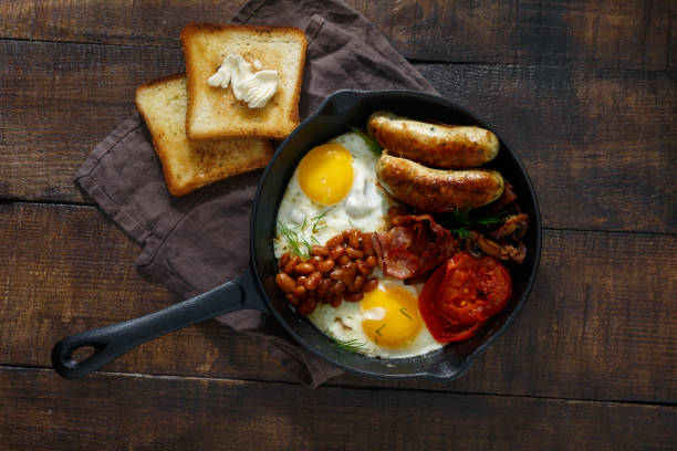 istock English breakfast on a dark wooden background, top view 914485332