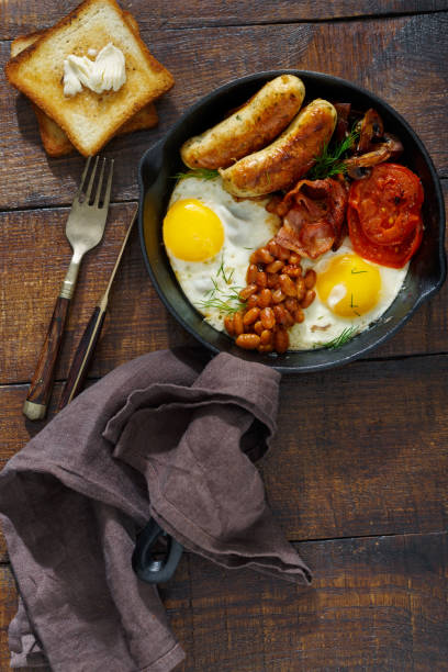 istock English breakfast on a dark wooden table, top view 914485850