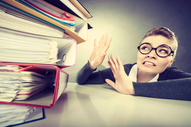 istock Accountant terrified of pils of binders. 914486126