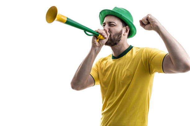 Brazilian male fan celebrating on white background