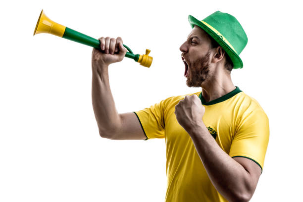 istock Brazilian male fan celebrating on white background 914487664