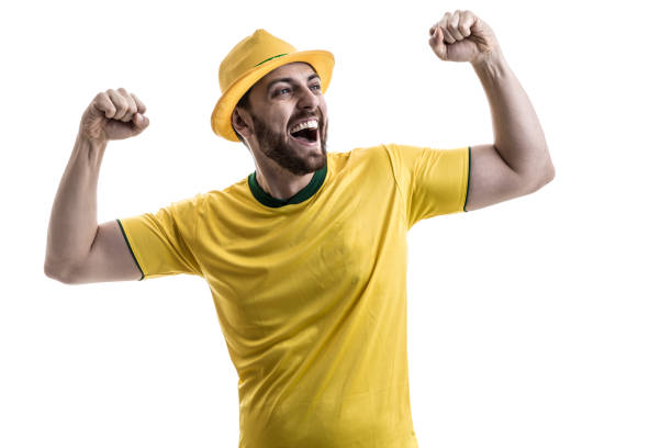 istock Brazilian male fan celebrating on white background 914487686