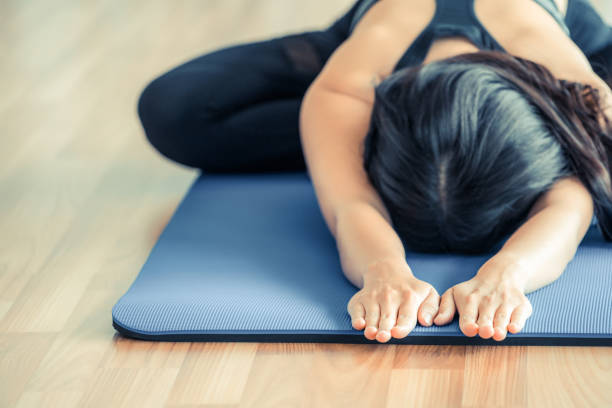 istock Woman practicing yoga pose in gym 914490758