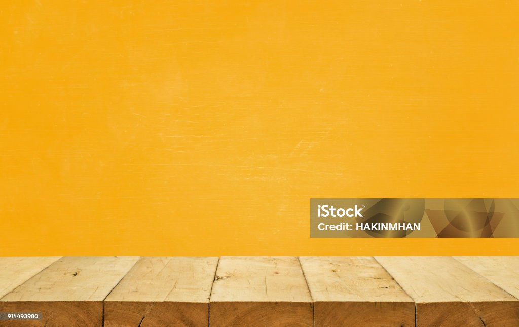 Wood table top on yellow color background.For montage product display or design key visual layout Empty wood table top on yellow color background.For montage product display or design key visual layout Table Stock Photo