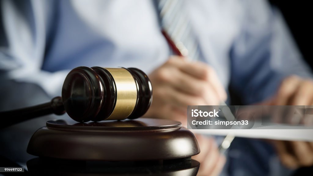 Lawyer in office with gavel, symbol of justice Lawyer in office with gavel, symbol of justice. Legal authority rights concept Finance Stock Photo
