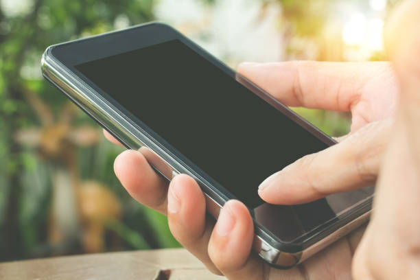 istock Close up of touch hands holding telephone copy space with sunset background. 914497158