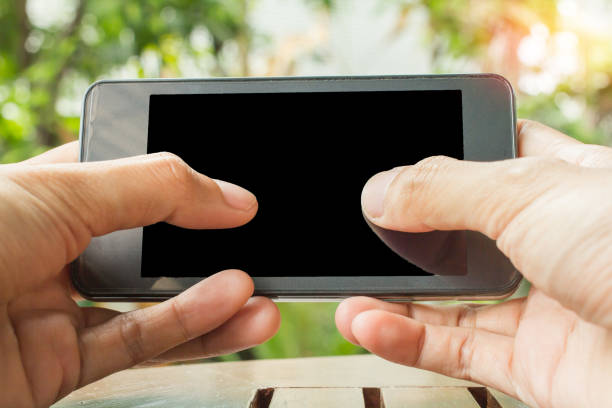 istock Close up of hands holding telephone copy space with sunset background. 914497170
