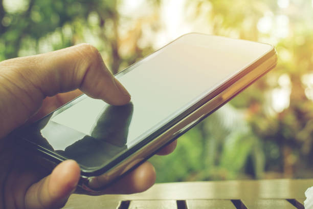 istock Close up of touch hands holding telephone copy space with sunset background. 914497198