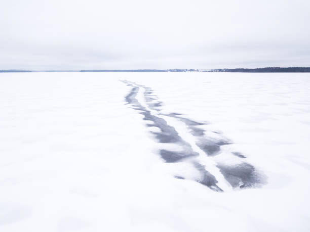 istock Melted snowmobile tracks on a frozen lake. 914497852