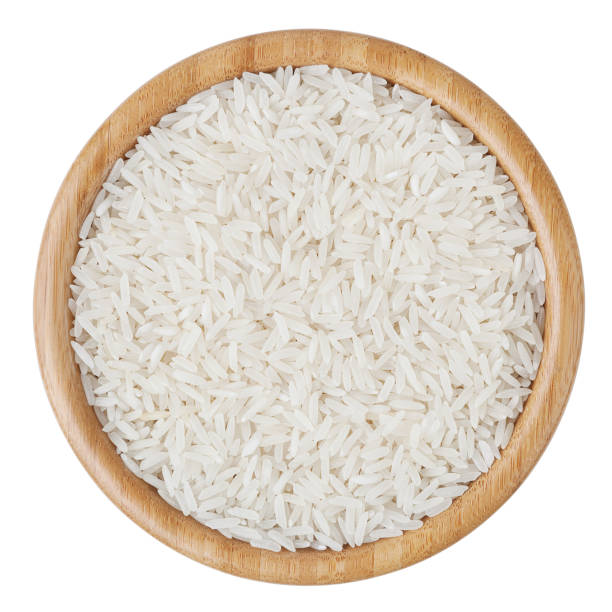 Top view of white long-grain rice in wooden bowl isolated on white background with clipping path Top view of white long-grain rice in wooden bowl isolated on white background with clipping path basmati rice stock pictures, royalty-free photos & images