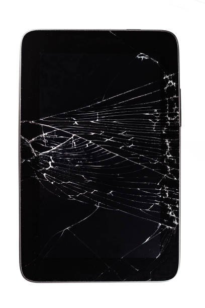 Tablet with a broken screen on a white background. Tablet with a broken screen on a white background. A thin grid of cracks on the glass of the tablet. broken digital tablet note pad cracked stock pictures, royalty-free photos & images