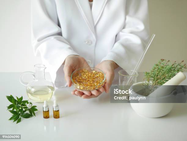 Scientist Or Doctor Making Herbal Medicine With Herb Leaves Capsule Tabletshands Stock Photo - Download Image Now