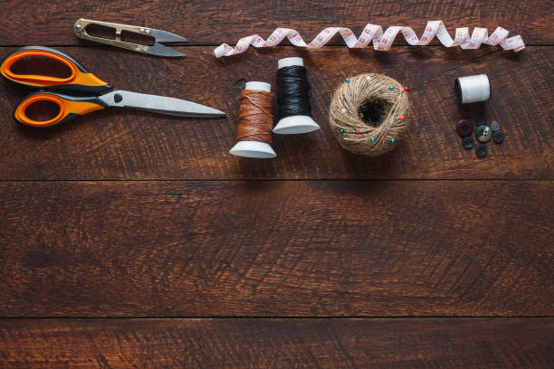 istock Top view aerial image fashion designer background concept.Flat lay sewing accessory or tailor tool work shop on modern rustic brown wooden at home office desk studio.Space for creative design mock up. 914512708